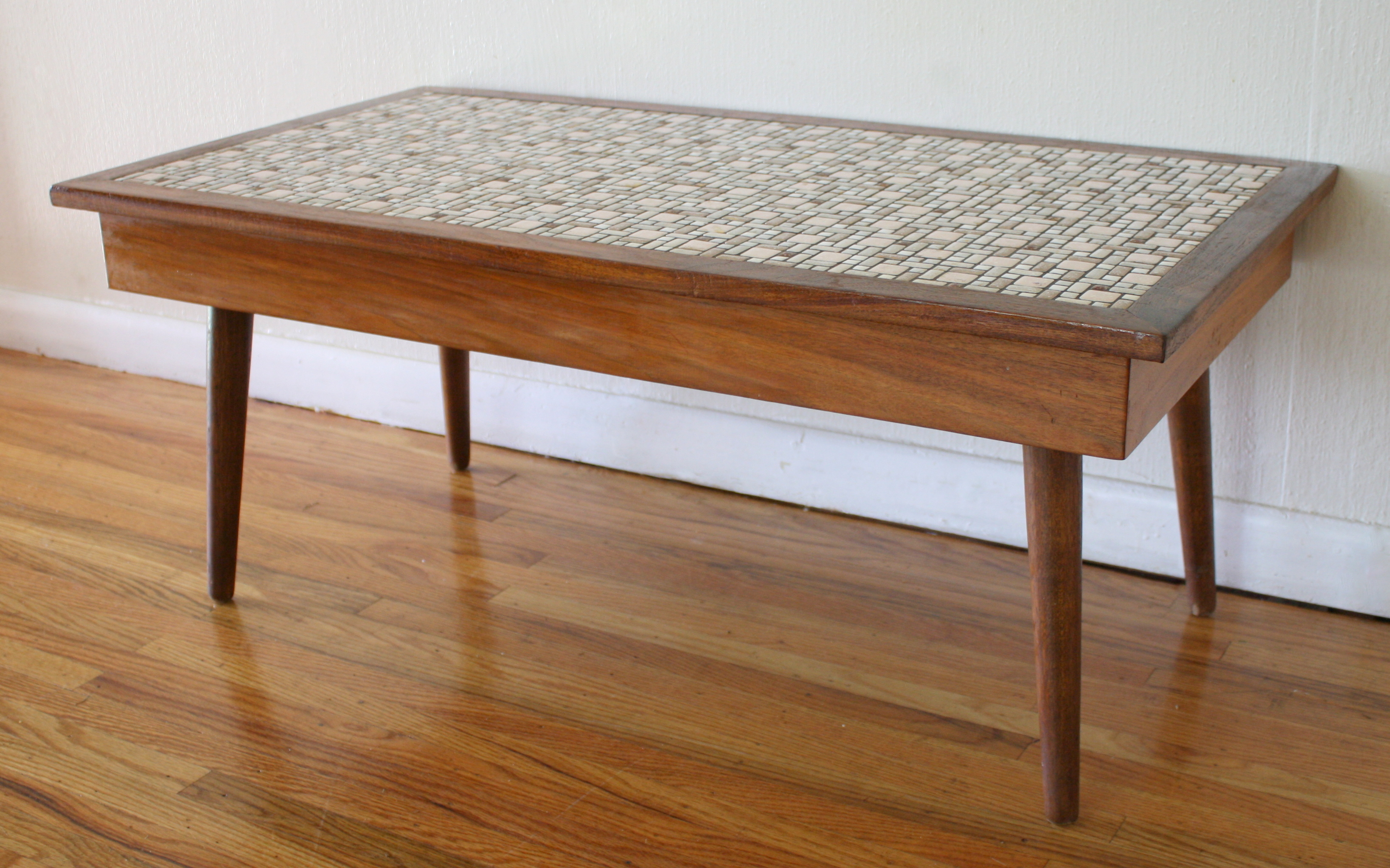 This is a mid century modern coffee table with beautiful retro tile 